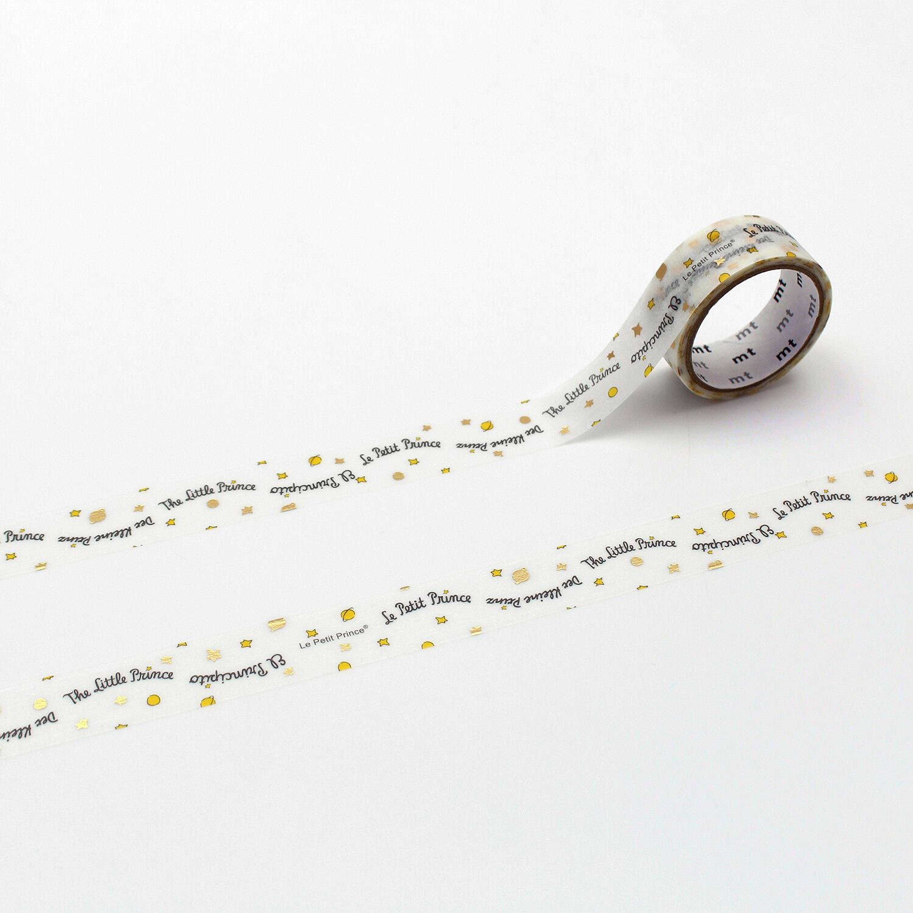 A roll of tape with the text "The Little Prince" printed on it, along with small stars and dots.