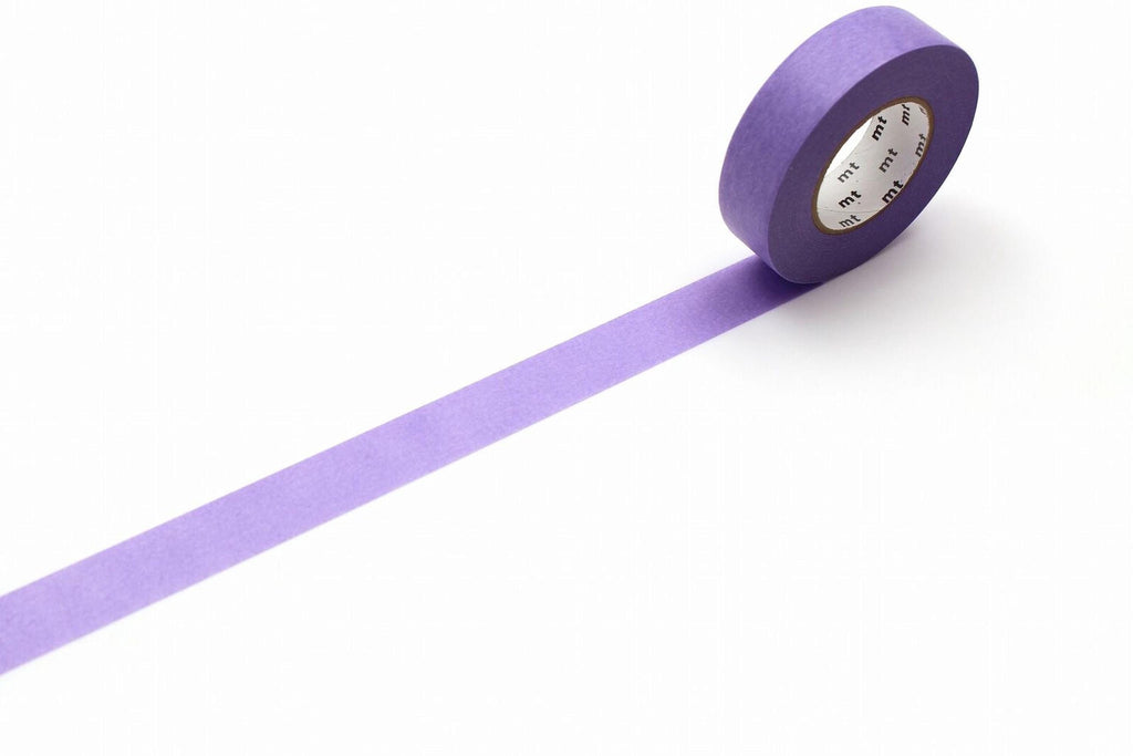 A roll of purple masking tape is lying on a white surface, with a single purple strip extending from the tape.