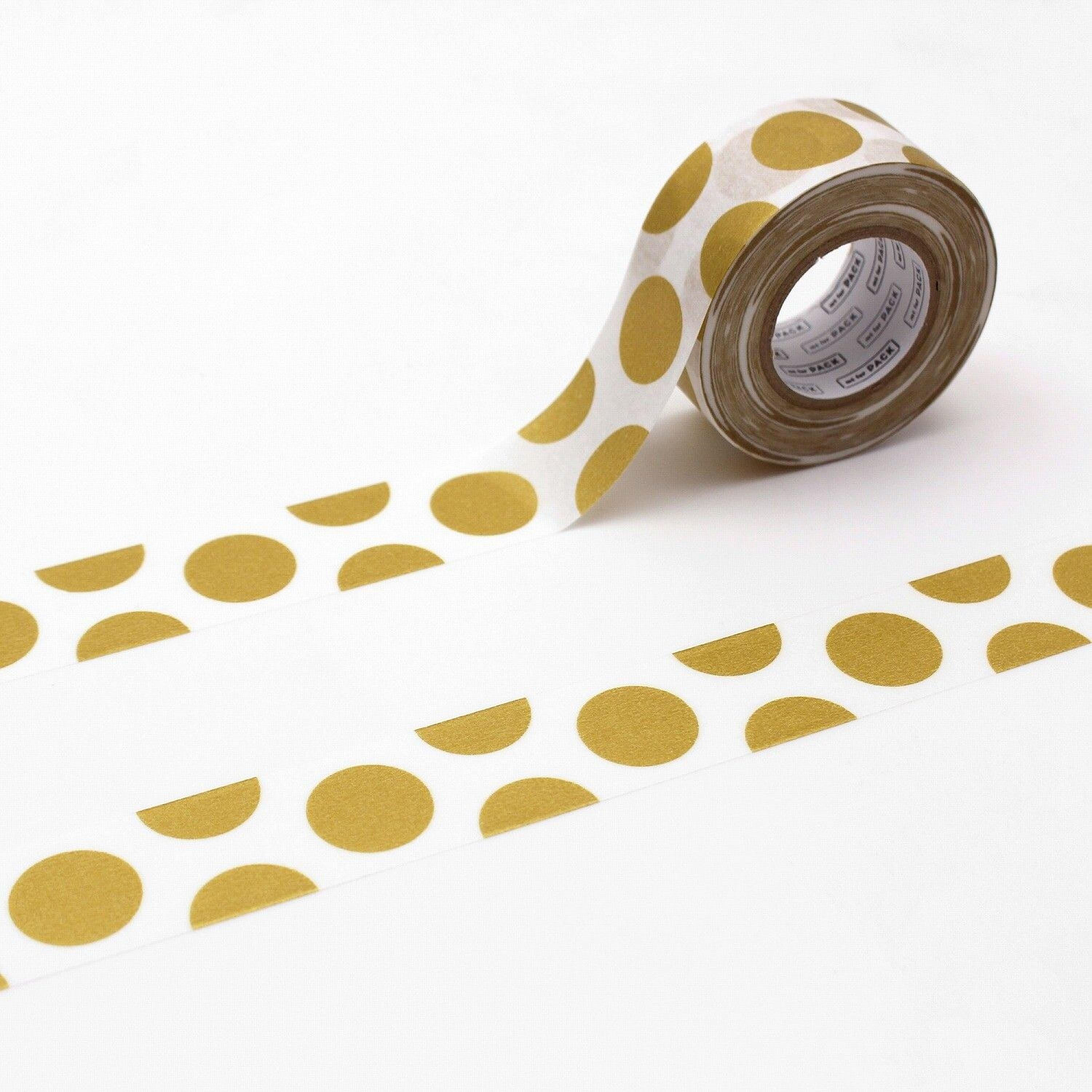 A roll of tape with a pattern of gold circles on a white background.