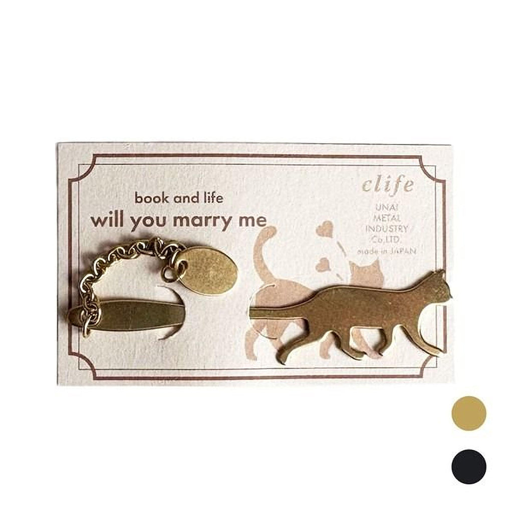a keychain in the shape of a cat, with a small tag attached to it.