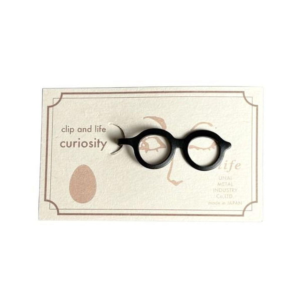 A pair of black glasses with a tag that reads "life" and "UNAI Metal Products Co., Ltd."