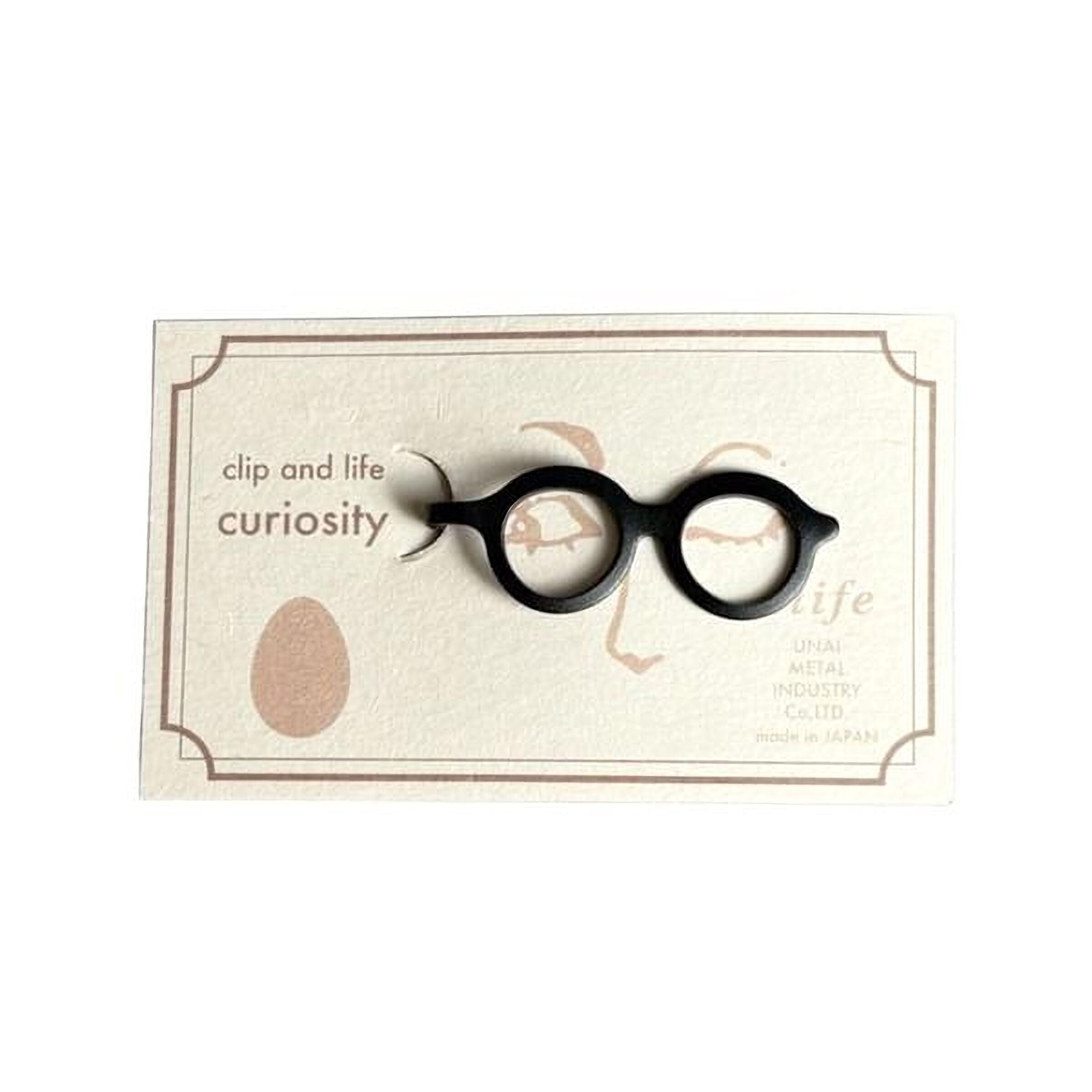 A pair of black glasses with a tag that reads "life" and "UNAI Metal Products Co., Ltd."