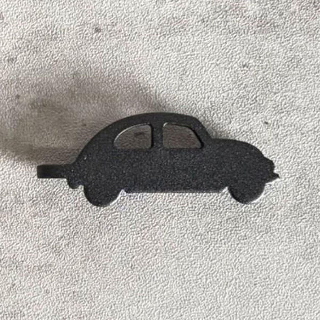 A black silhouette of a car is shown against a textured gray background.