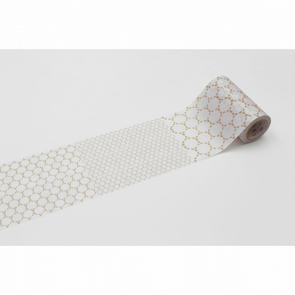A roll of patterned tape with a repeating hexagonal design on a white background.