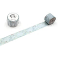 two rolls of patterned tape with a floral design, lying on a white surface.