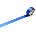 A roll of blue tape with a white label is lying on a white surface.