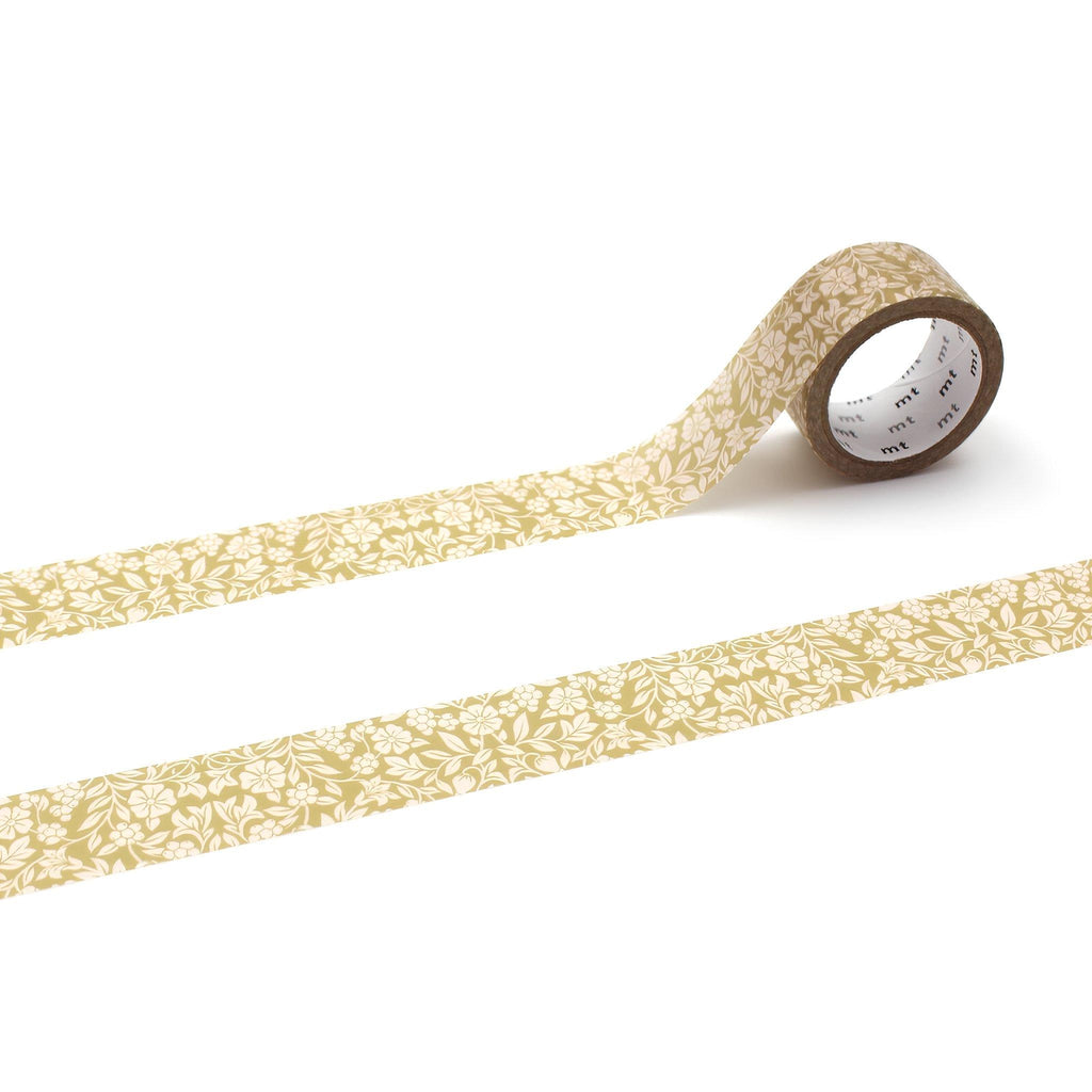 a roll of gold-colored floral patterned tape lying on a white background.
