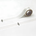 a roll of clear tape with musical notes printed on it, placed on a white surface.
