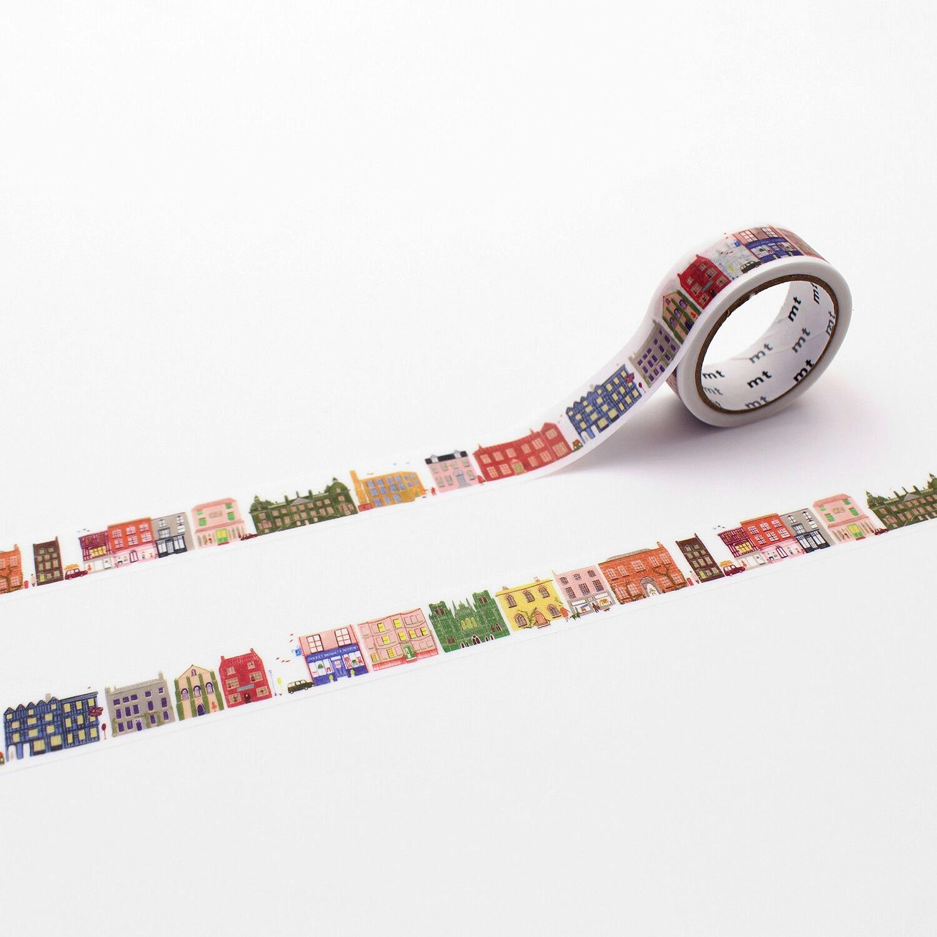 A roll of colorful tape with a repeating pattern of various colored houses on it, placed on a white background.