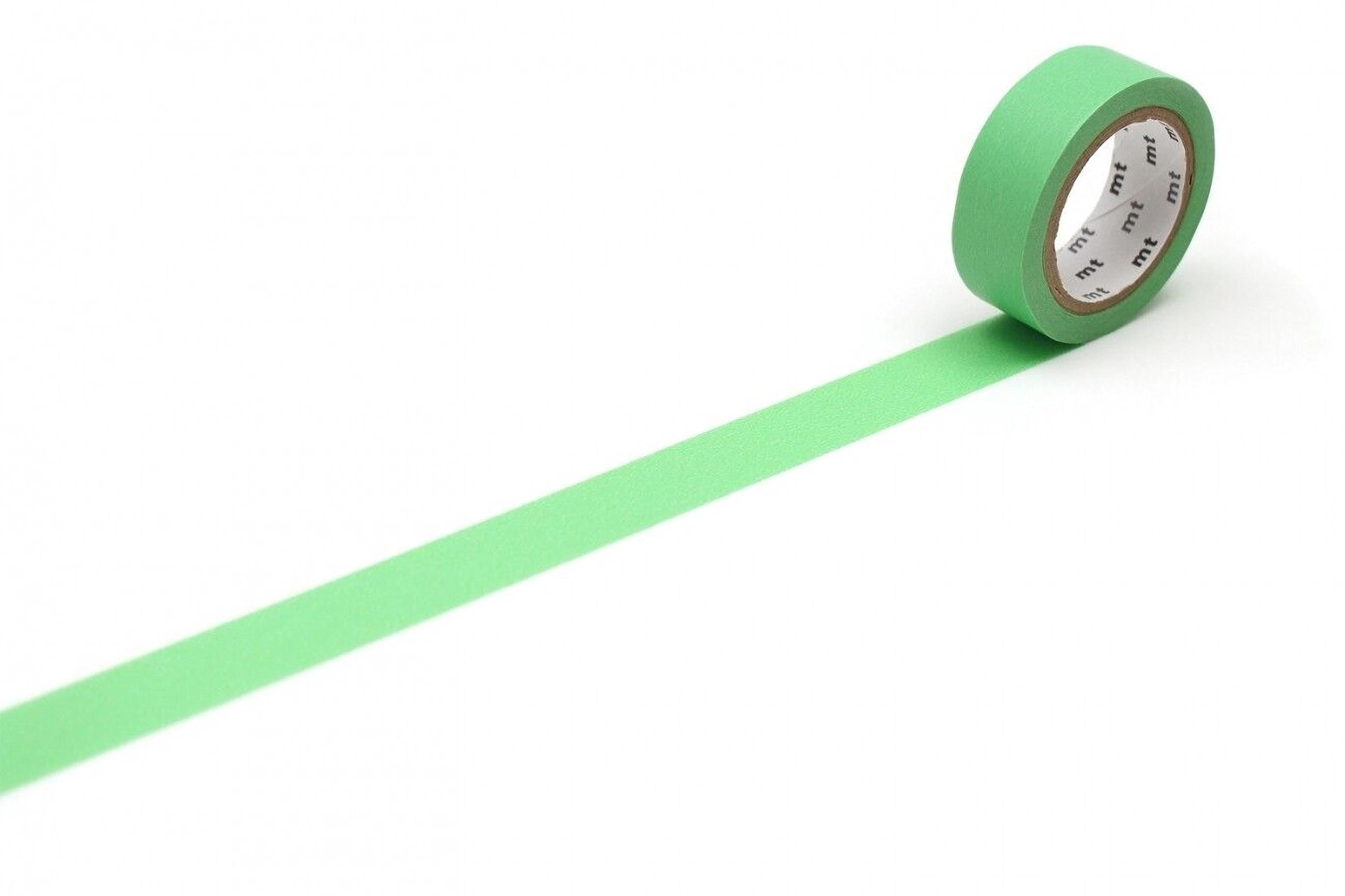 A roll of green masking tape is lying on a white surface, with a single green stripe visible on the tape.