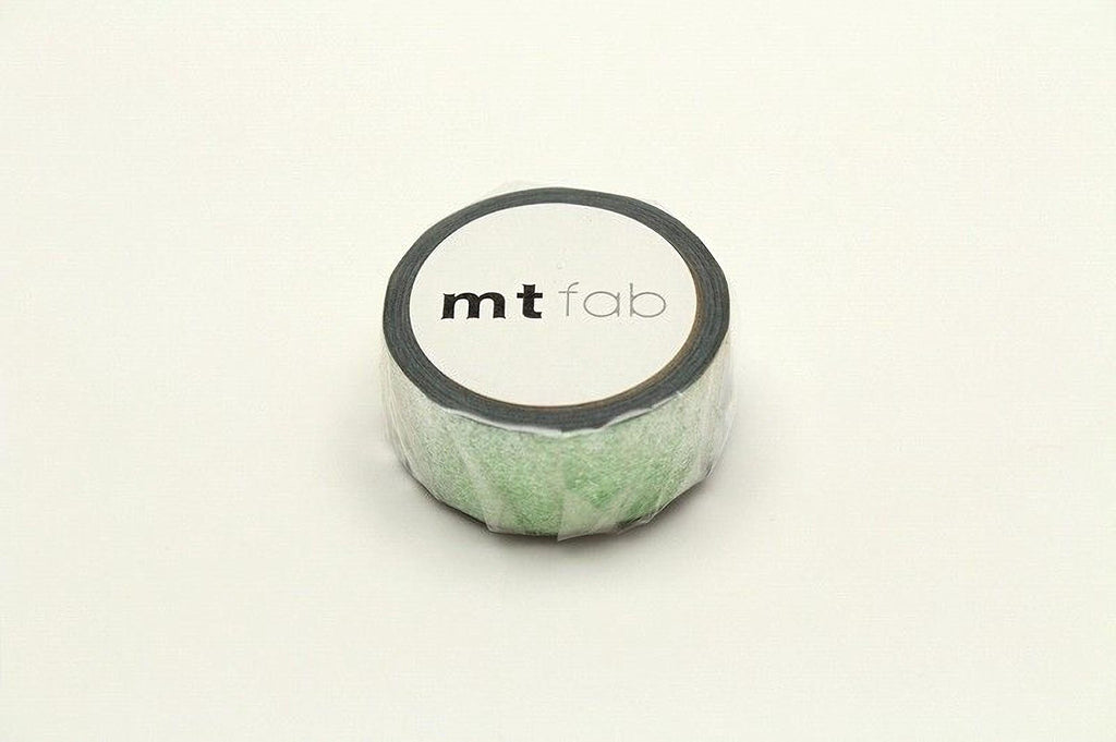 A roll of green and white tape with the text "mtFab" printed on it.
