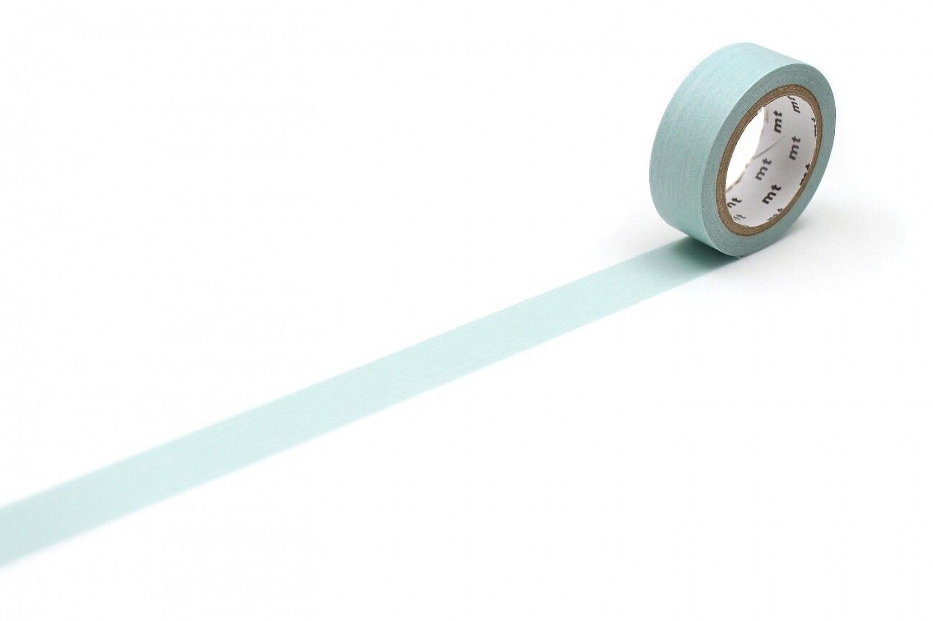 A roll of light blue tape with a white clock face on it is placed on a white surface, with a long light blue line extending from the tape.