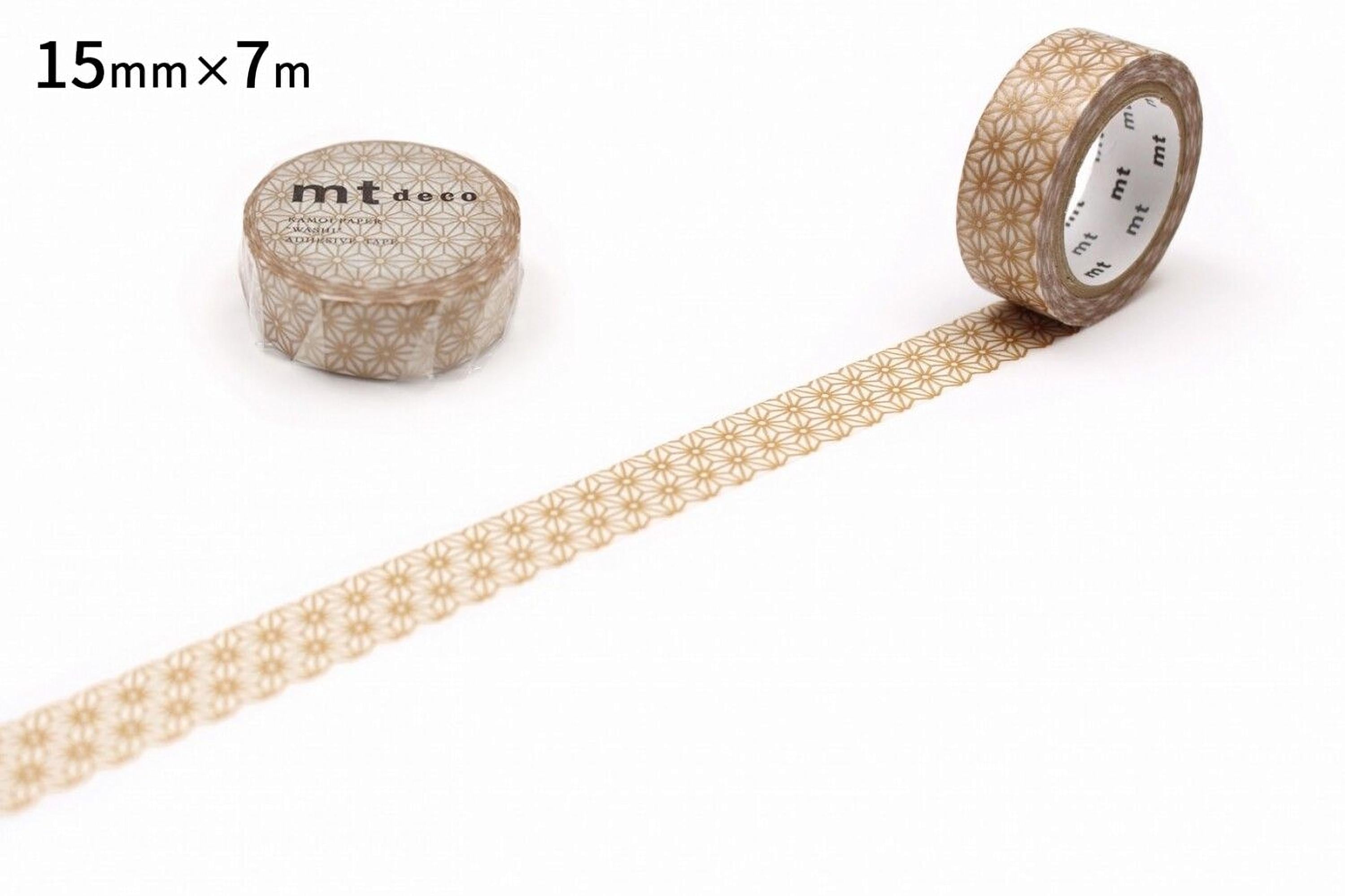 a roll of metallic gold-colored tape with a repeating pattern of small circles or dots, placed next to a roll of tape with a label indicating its size and brand.