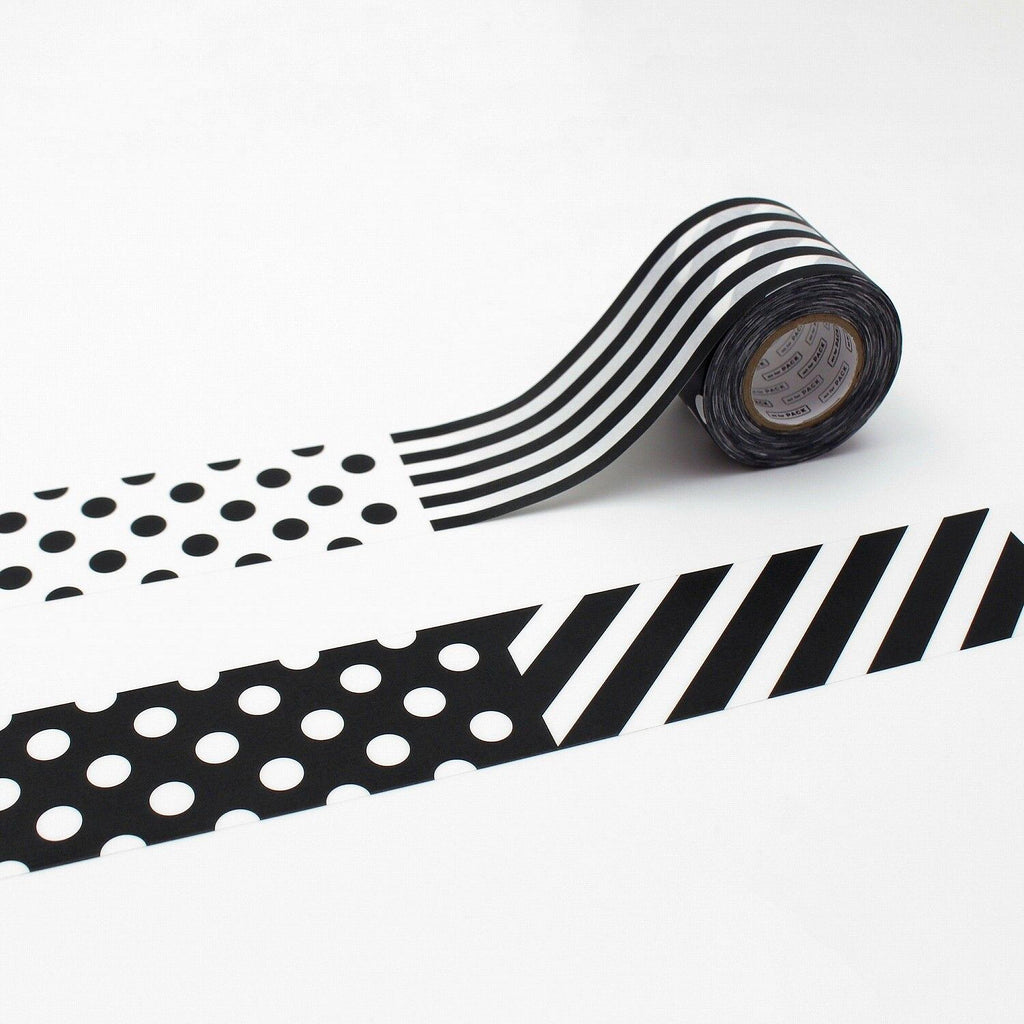 a roll of black and white striped tape with a pattern of polka dots and diagonal stripes.