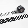 a roll of black and white striped tape with a pattern of polka dots and diagonal stripes.