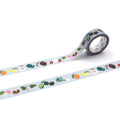 a roll of patterned tape with various fruits and vegetables printed on it, including apples, oranges, and bananas.