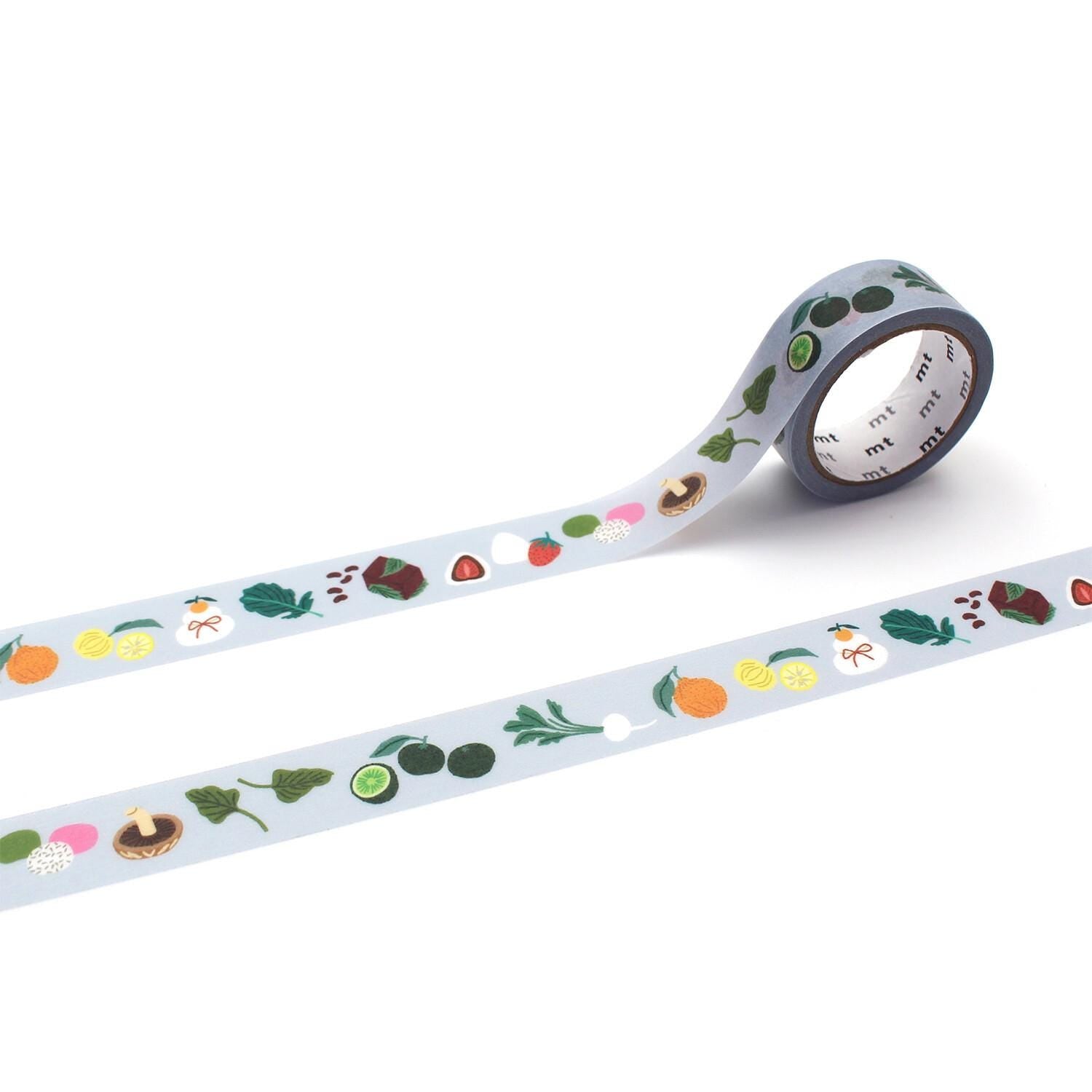 a roll of patterned tape with various fruits and vegetables printed on it, including apples, oranges, and bananas.