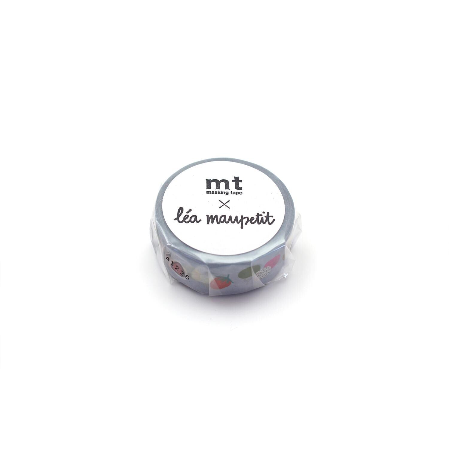 A silver-colored circular object with a label that reads "mt lea maupeit" and some colorful stickers on it.