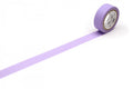 A roll of purple washi tape is lying on a white surface, with a single strip of tape extending from the top of the roll to the bottom.