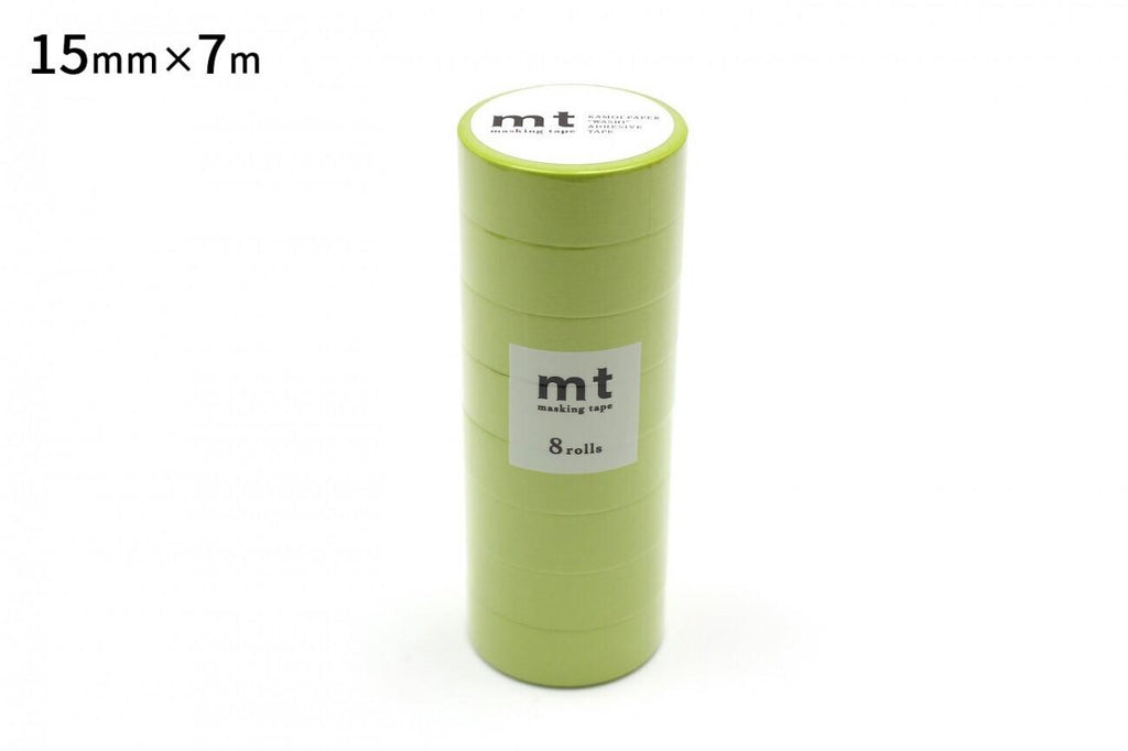 A stack of green cylindrical objects, likely some kind of container or packaging, with a label on the front.