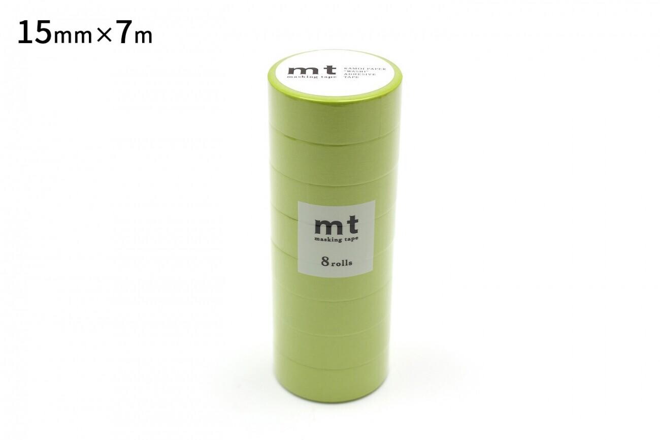 A stack of green cylindrical objects, likely some kind of container or packaging, with a label on the front.