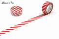 a roll of red and white striped tape with a label, placed on a white surface.