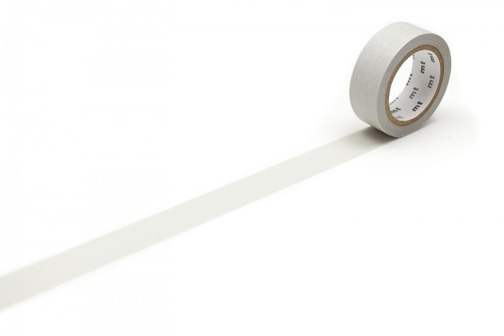 A roll of gray tape is lying on a white surface, with a shadow cast by the tape.