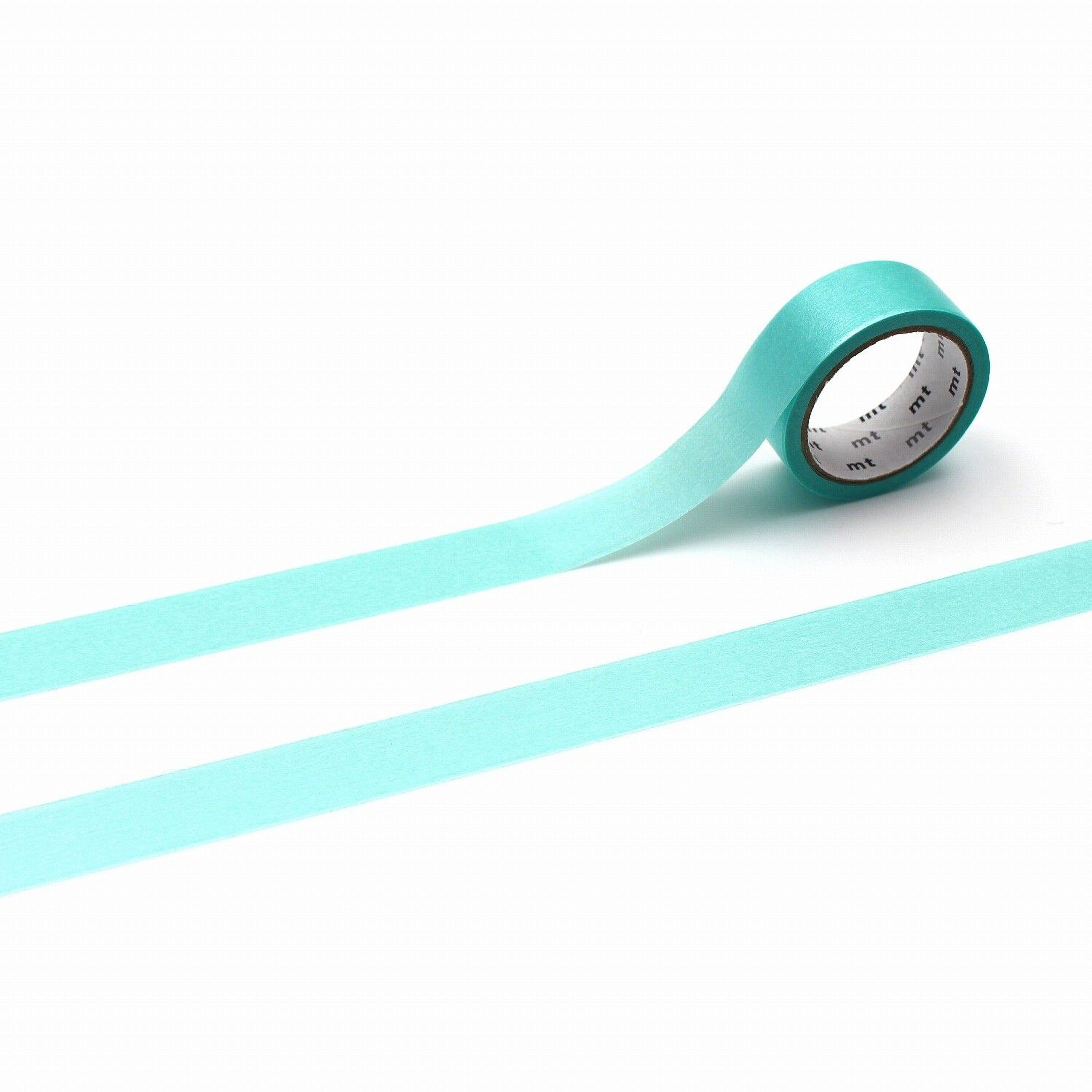 A roll of turquoise-colored tape is lying on a white surface, with a single blue line extending from the tape.