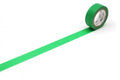 A roll of green tape with a white label is placed on a white surface, with the tape extending across the image.