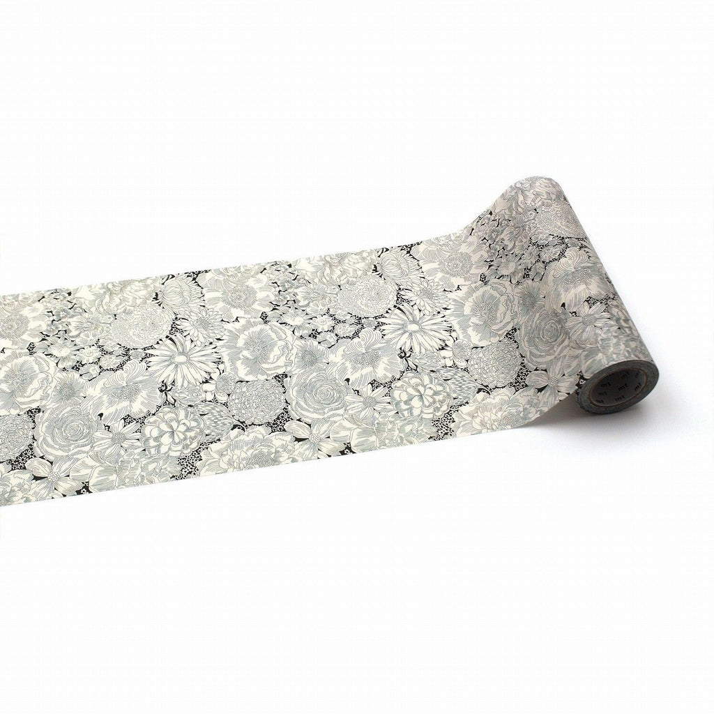a roll of paper with a floral pattern on it, placed on a white background.