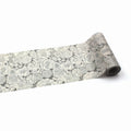 a roll of paper with a floral pattern on it, placed on a white background.