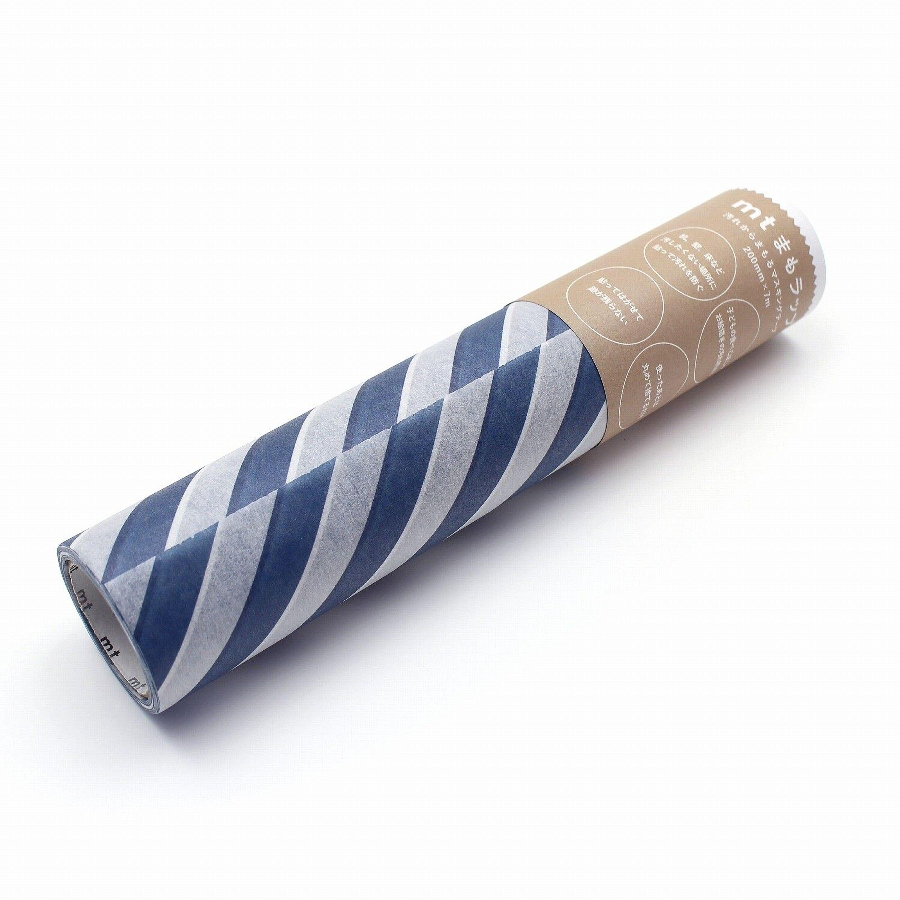 A cylindrical object with a striped pattern in shades of blue and white, and a brown cardboard tube with text on it.