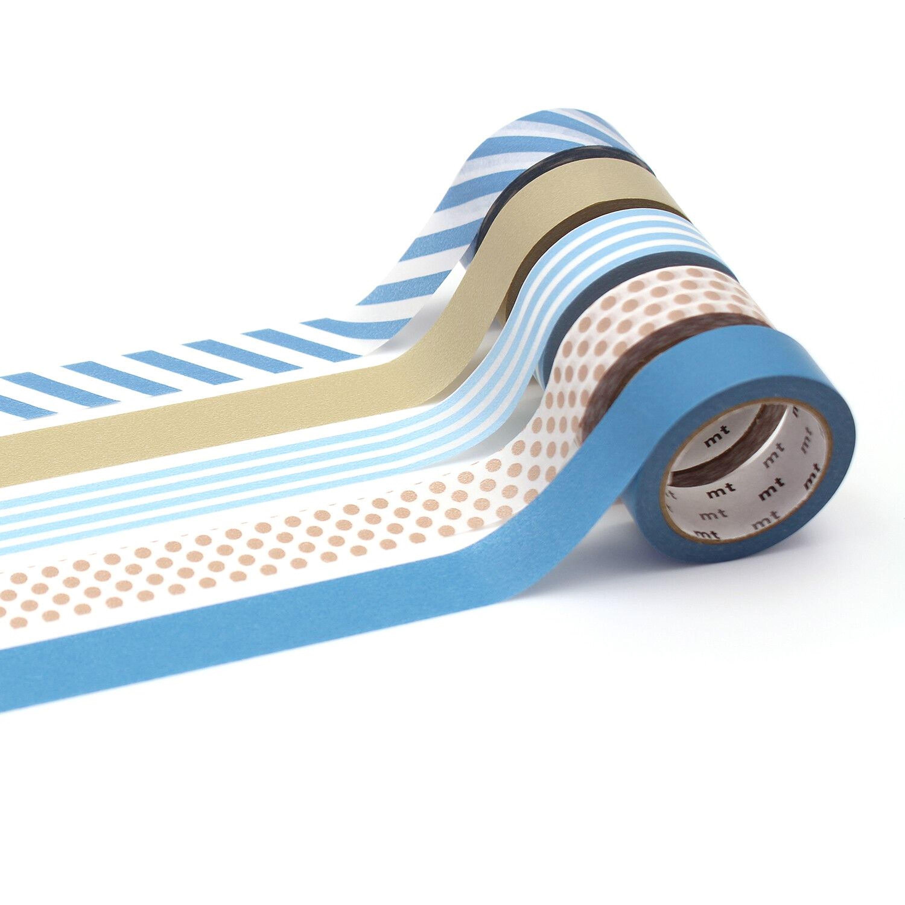 A roll of colorful patterned tape is shown, with various stripes and polka dots in shades of blue, white, and brown.