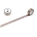 a roll of metallic silver and gold patterned tape with a repeating design, lying on a white surface.