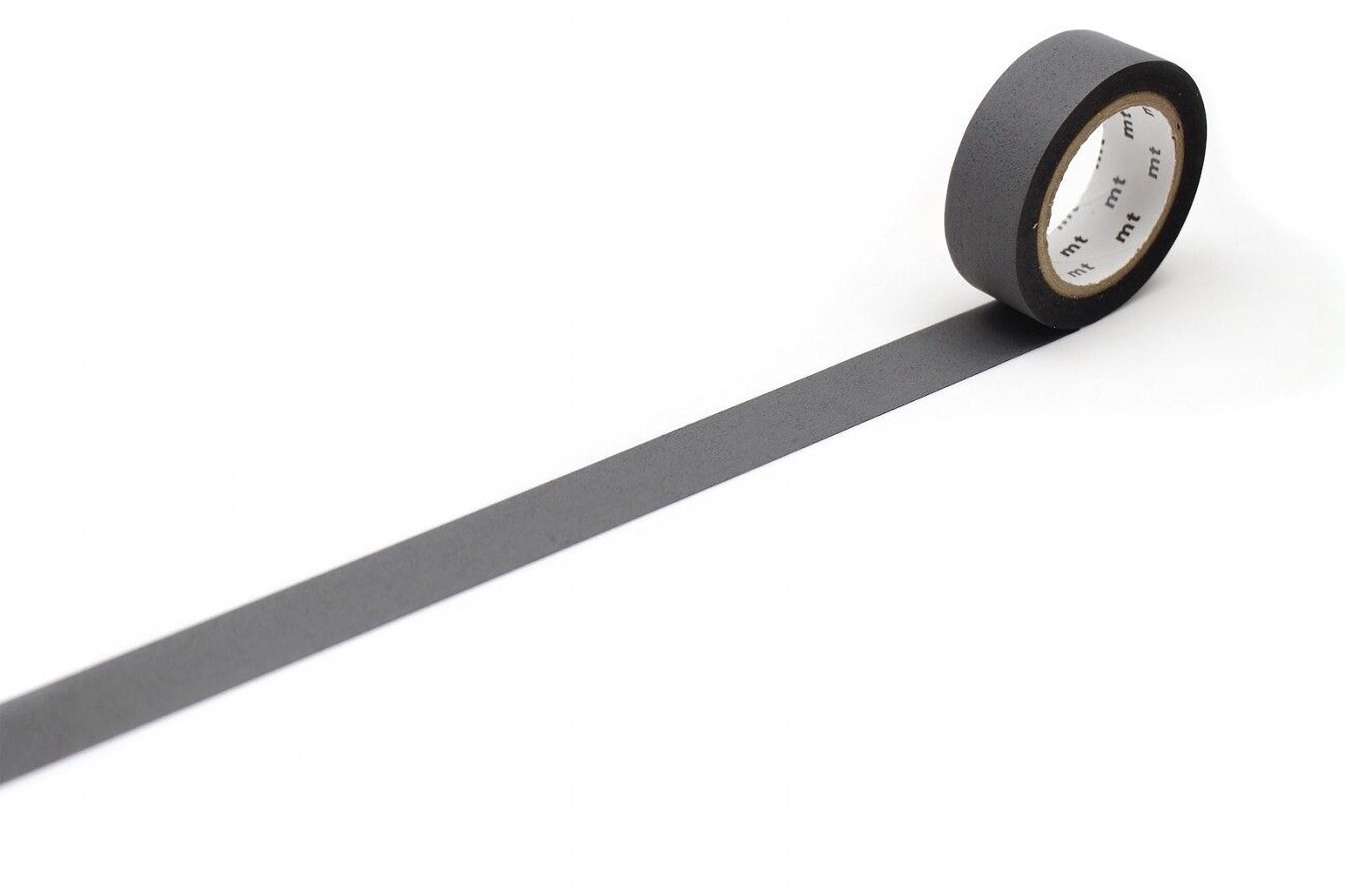 A roll of black tape with a white center is placed on a white surface, lying on its side.