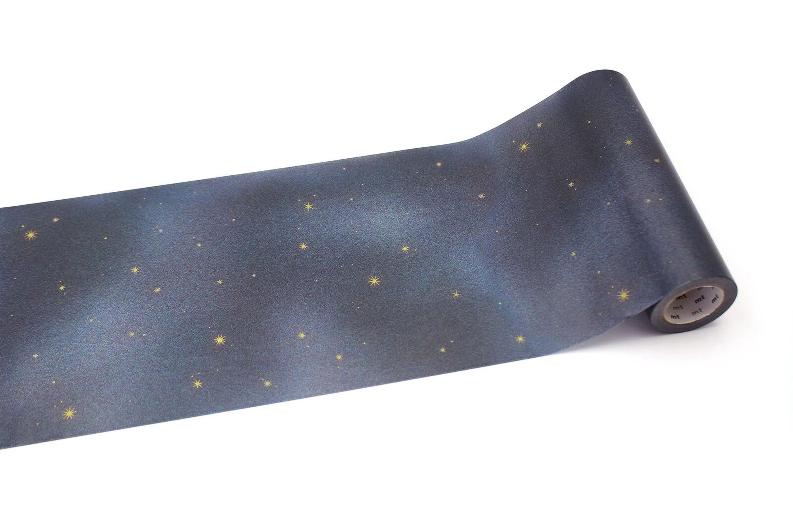 A roll of blue paper with a starry night sky pattern printed on it.