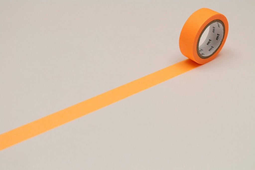 An orange roll of tape is lying on a white surface, with a single orange line extending from the tape.