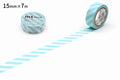 a roll of blue and white striped tape on a white background, with a strip of tape on the floor.