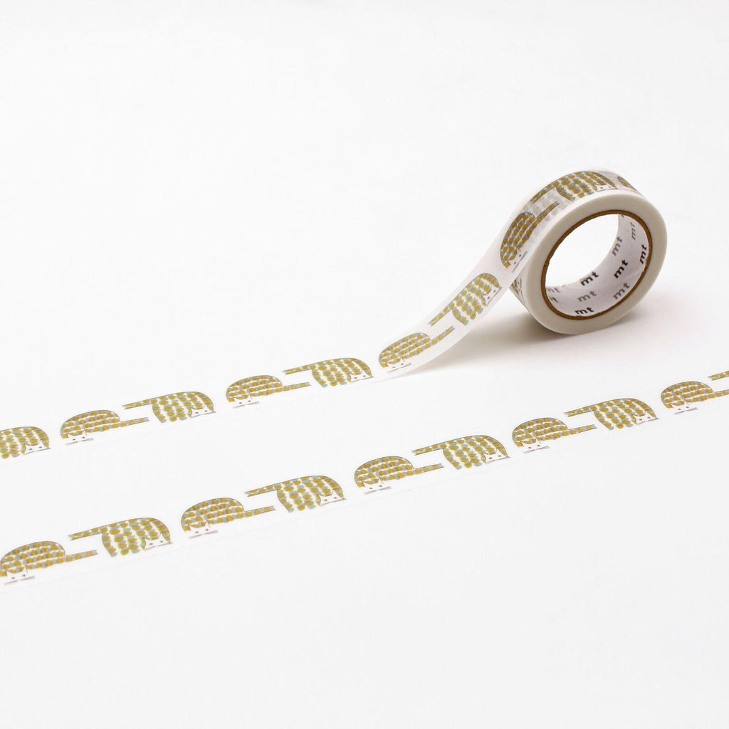 a roll of white tape with a repeating pattern of gold and white designs, including a sloth, on it.