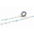 a roll of patterned tape with a colorful design on it, lying on a white surface.