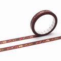 a roll of red and gold patterned tape with a repeating design of small animal figures, such as bears and birds, on a white background.