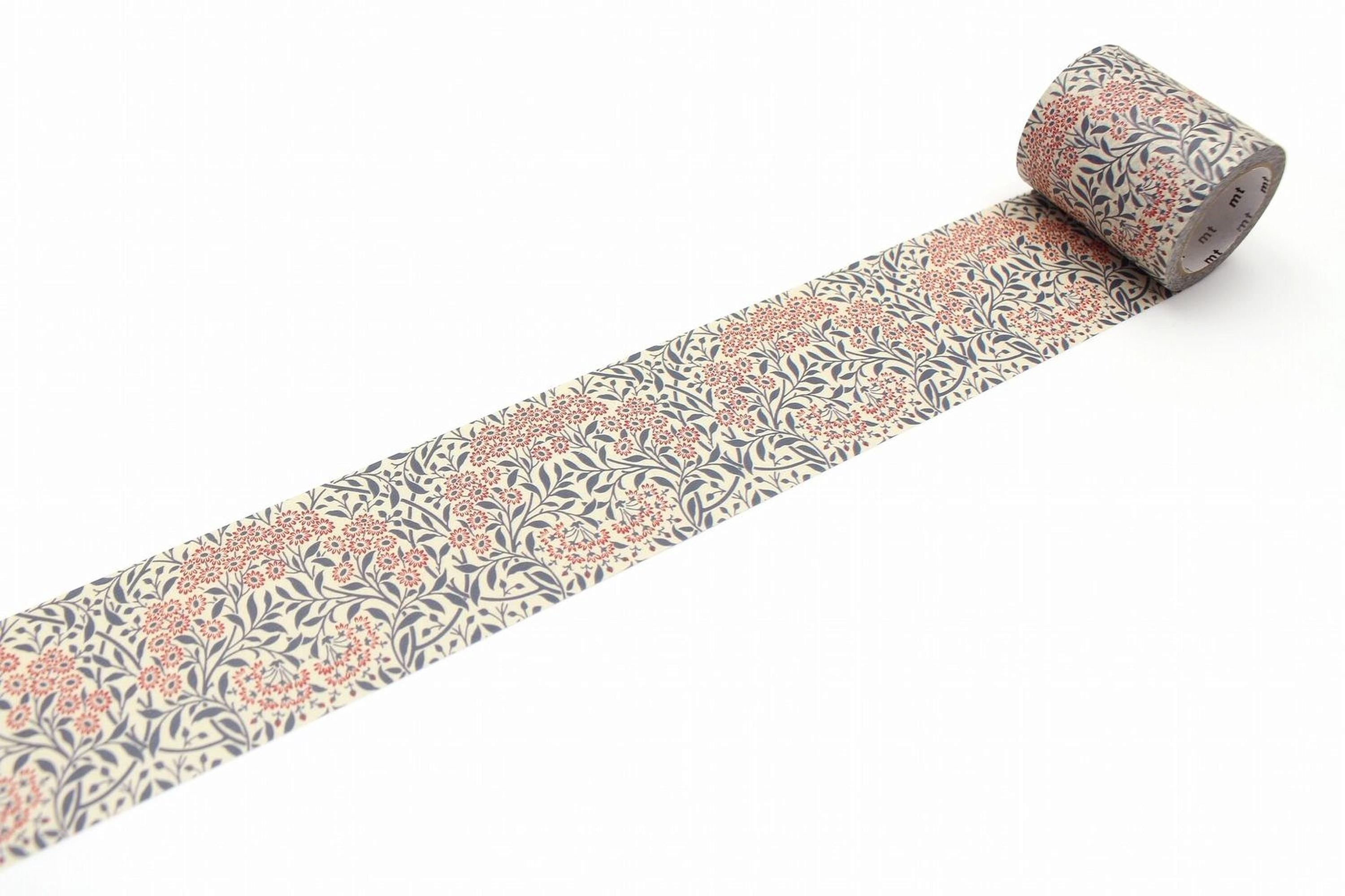 A roll of patterned tape with a floral design in shades of blue and orange.