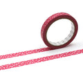 A roll of red heart-patterned tape is lying on its side on a white background, with two horizontal stripes of the same tape pattern visible.
