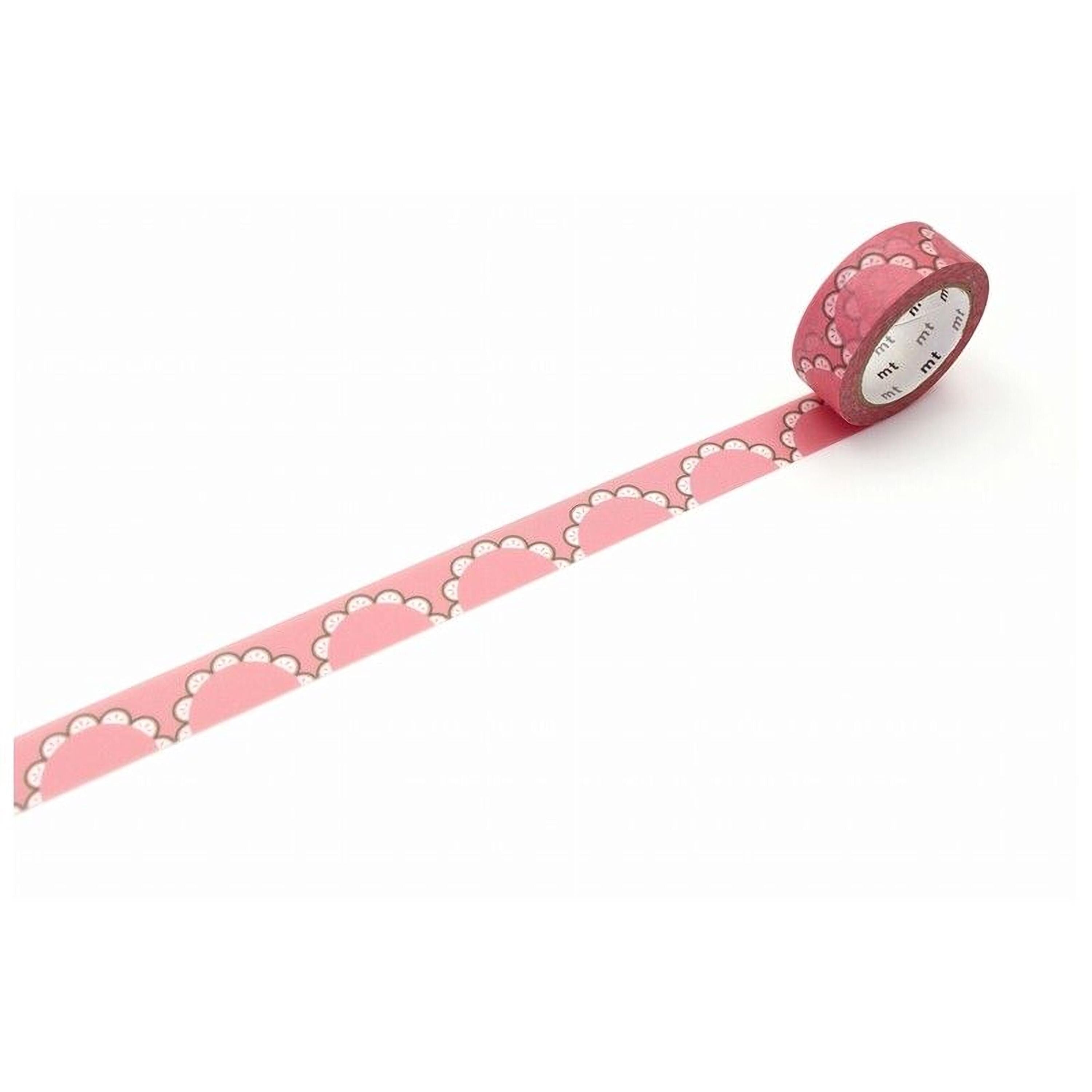 A pink scalloped edge tape is lying on a white surface, with a clock face visible on the tape.