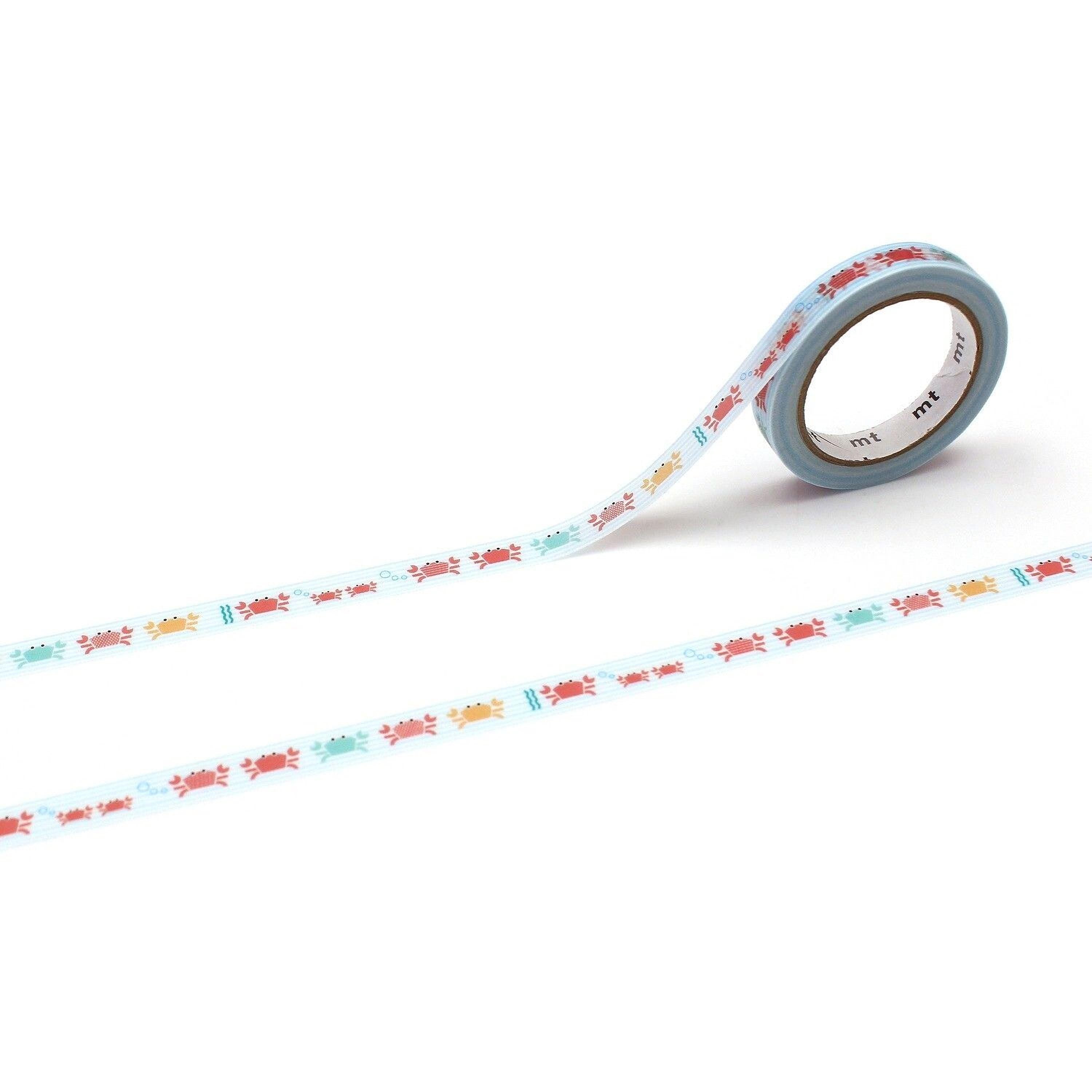 a roll of blue and white patterned tape with a repeating design of red and yellow crabs on a white background.