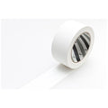 A roll of white tape with a black and white pattern on it, lying on a white surface.