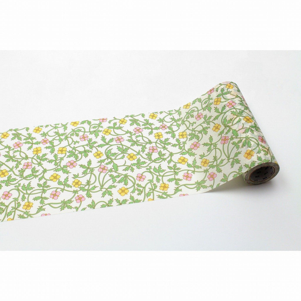 A roll of paper with a floral pattern of green leaves and yellow flowers.