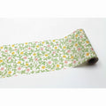 A roll of paper with a floral pattern of green leaves and yellow flowers.