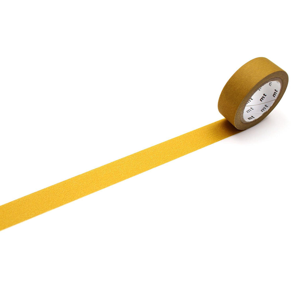 A roll of yellow tape with a white label is lying on a white surface, with a yellow line extending from the tape.