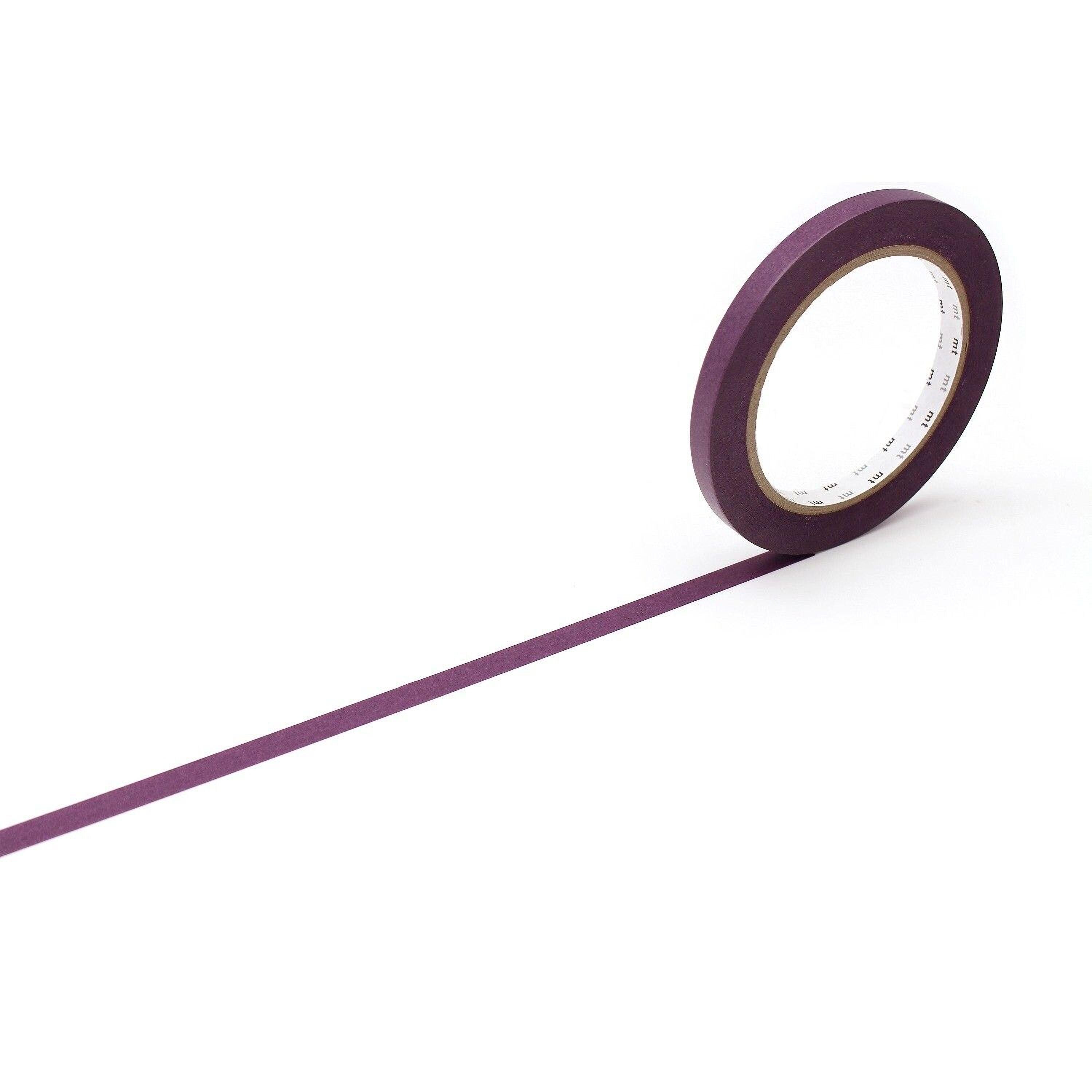 A roll of purple tape is lying on its side on a white background.